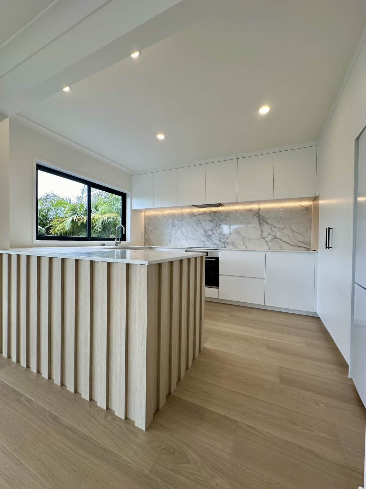 Remuera renovation kitchen with fluted oak island and marble benchtop